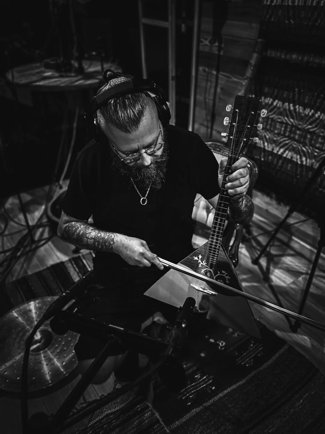 Michał Staczkun playing a folk instrument in the studio